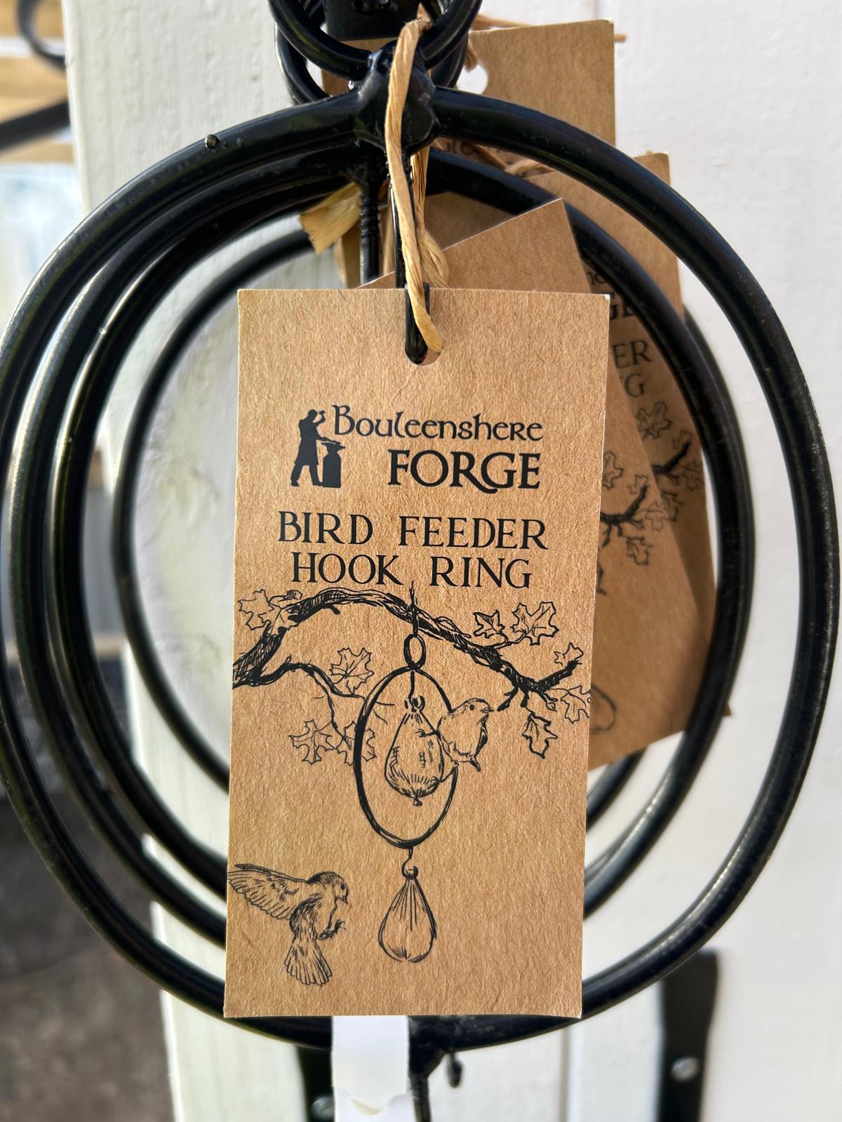 Irish hand-forged iron bird feeder hook ring by Boyleenshere Forge with rustic kraft paper label showing blacksmith logo and bird illustration